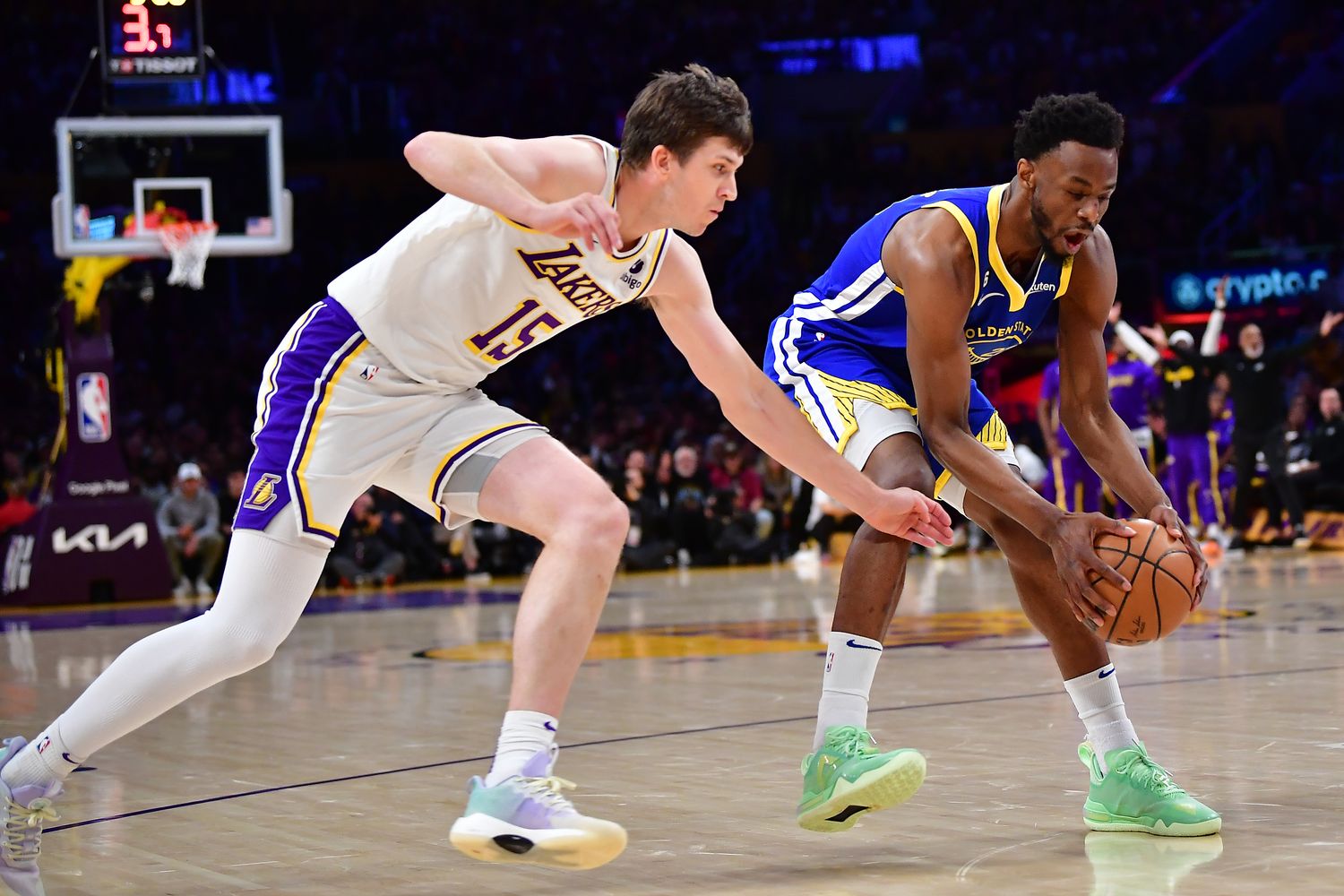 Lakers guard Austin Reaves tries to steal the ball from Warriors guard Andrew Wiggins.